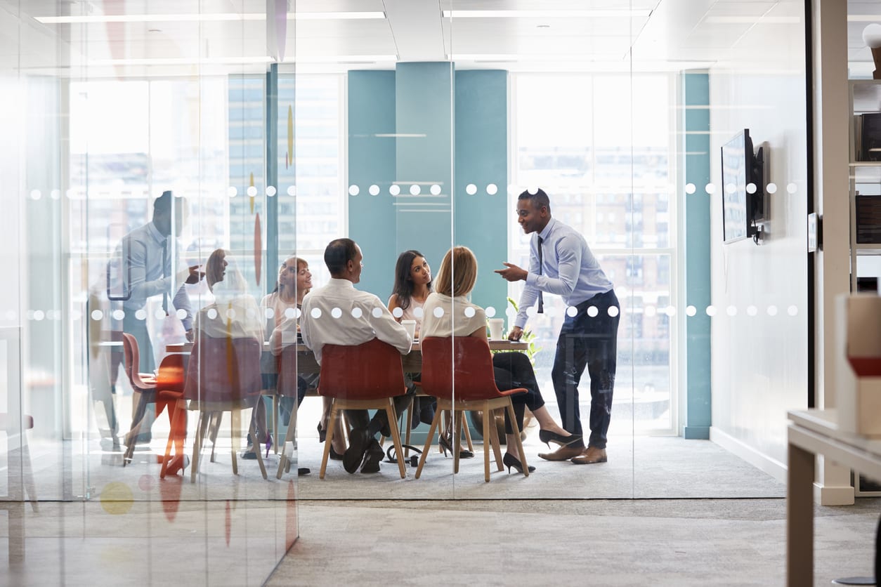 Colleagues chat informally in boardroom