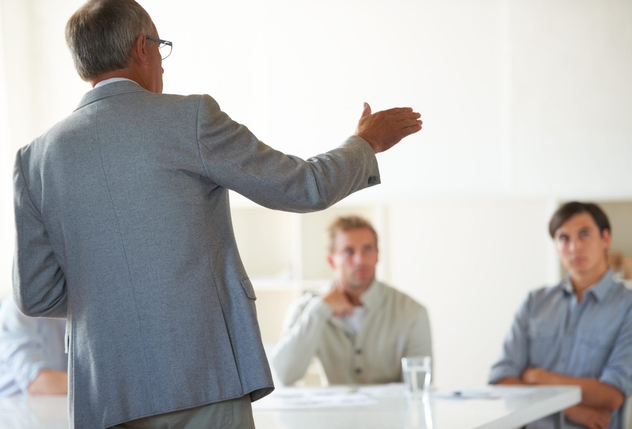 Business man speaks to colleagues