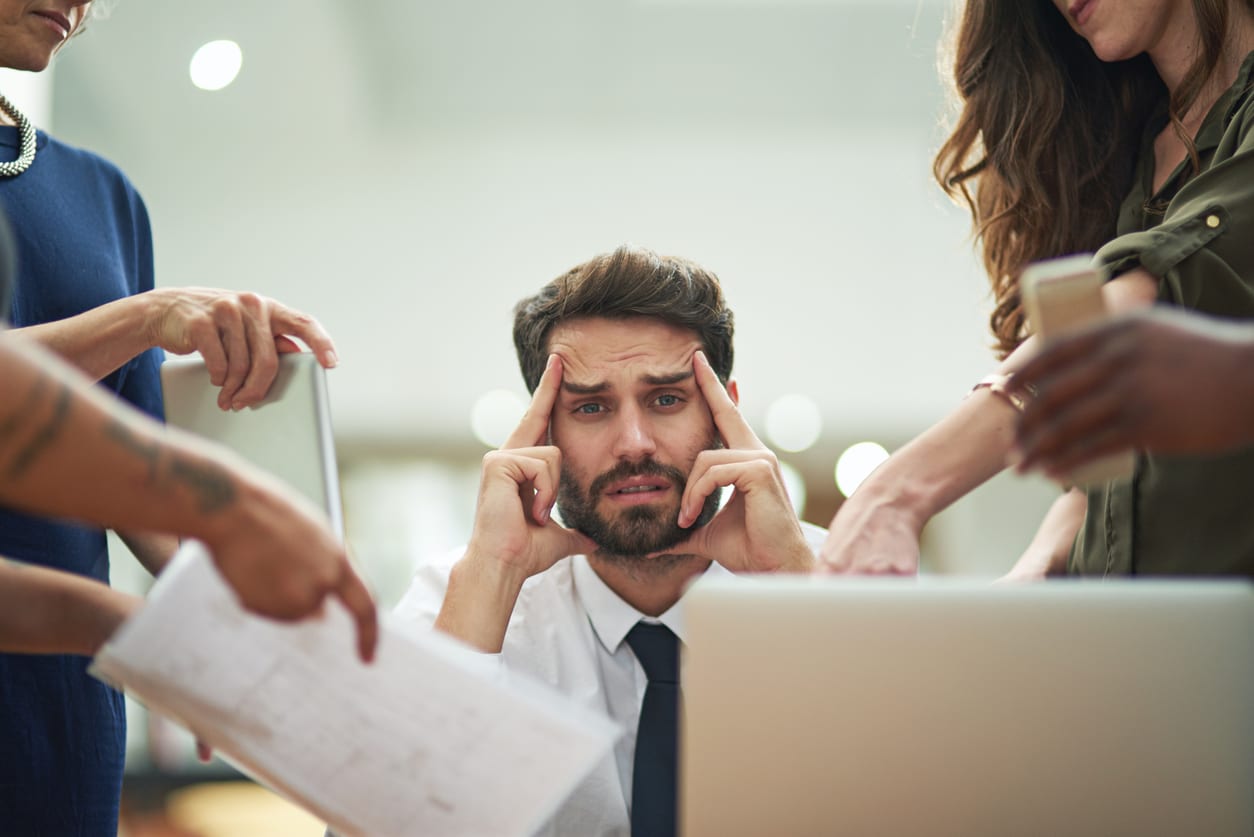 Cropped portrait of a young businessman feeling overwhelmed by work