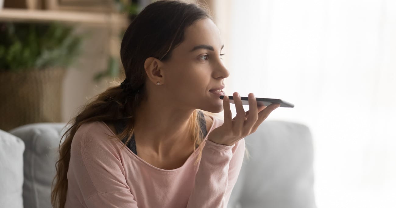 woman talking into smartphone