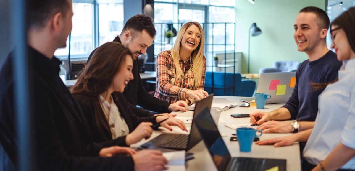 colleagues laughing in meeting