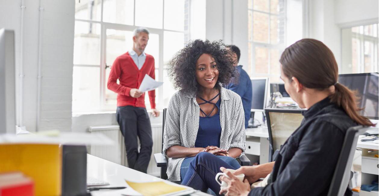 A female manager speaking with a member of her team