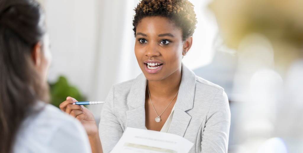 business women discussing document