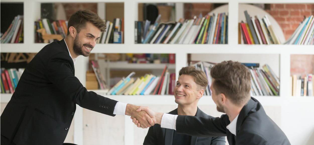 Businessman greeting colleagues