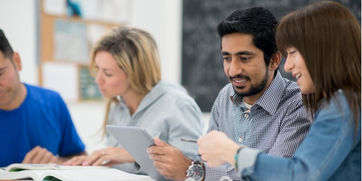 Two colleagues do research on a tablet