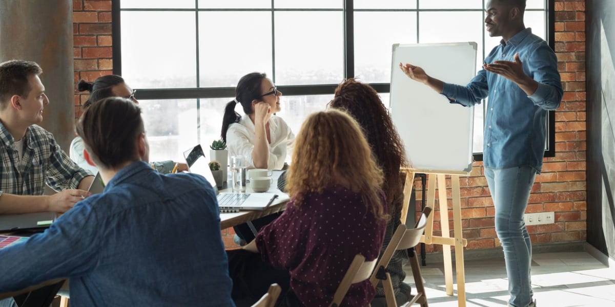 Man speaking to employees in a business meeting