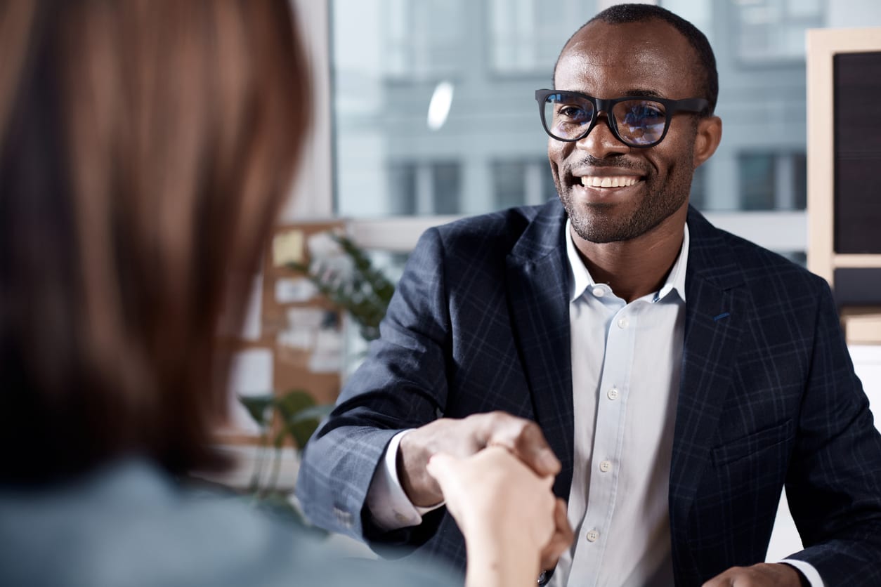 Smiling businessman shakes hands