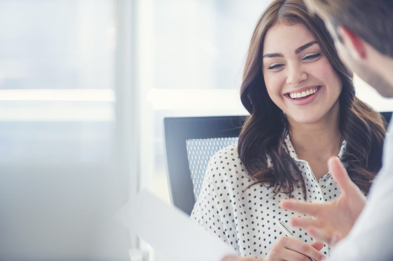 Business woman smiling with pen