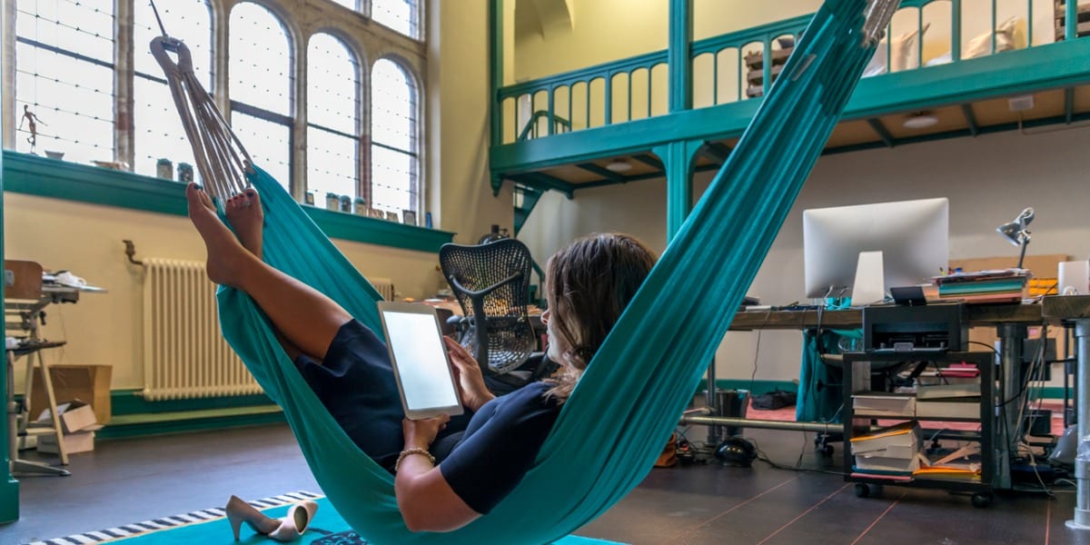 Young woman relaxing on tablet in an office