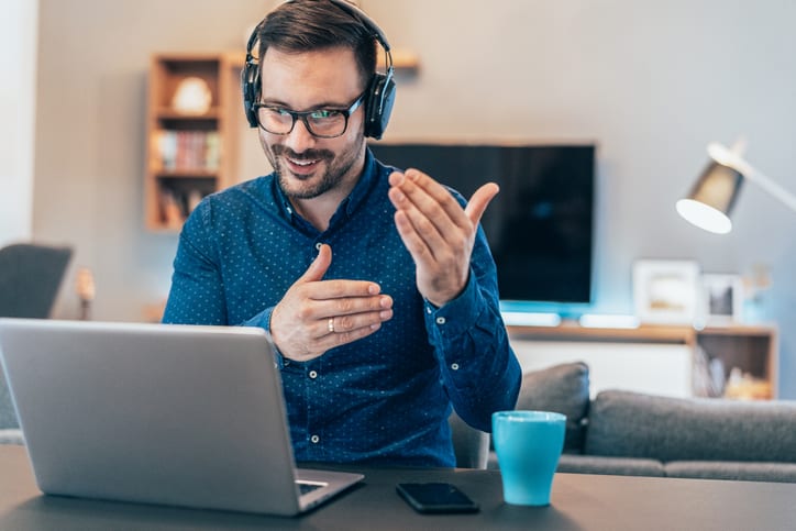 man talking on conference call over laptop