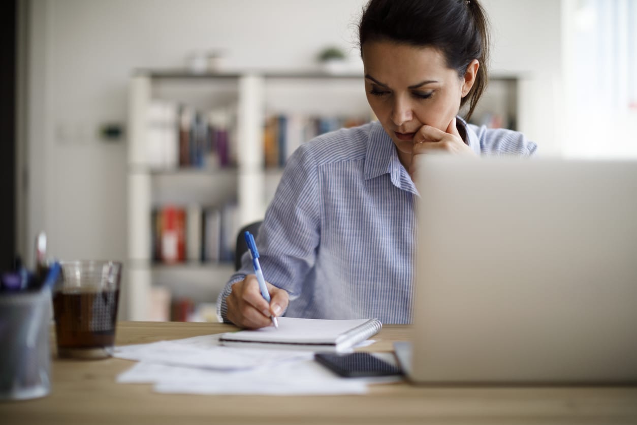 woman writing notes in diary