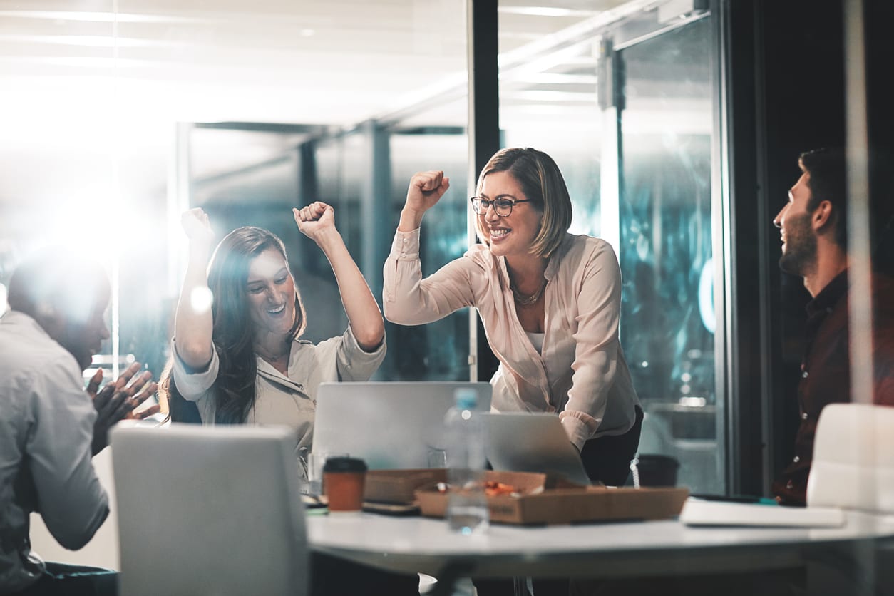 joyful female colleagues celebrating