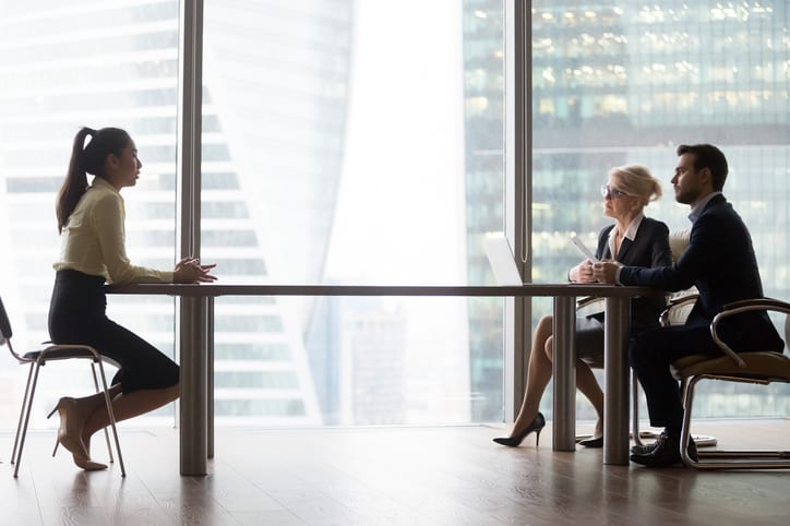 Asian applicant introducing talking to hr managers at job interview in modern office, recruiters interviewing listening to vacancy candidate recruiting sitting at table, hiring and employment concept