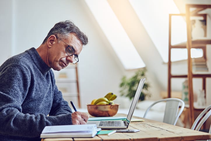 Shot of a senior man using a laptop at home