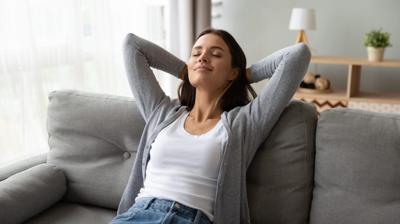 woman relaxing on her sofa