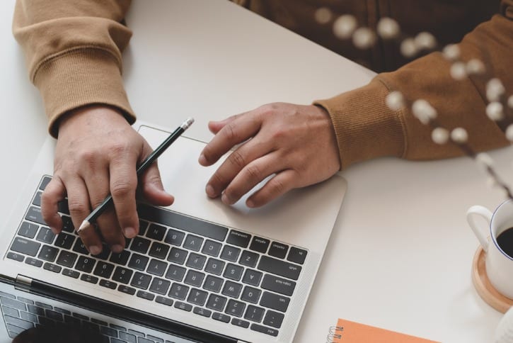 hands typing on laptop