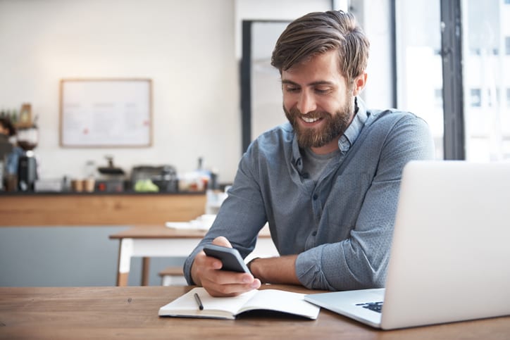 smiling man looking at his phone