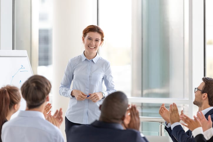 colleagues applauding worker