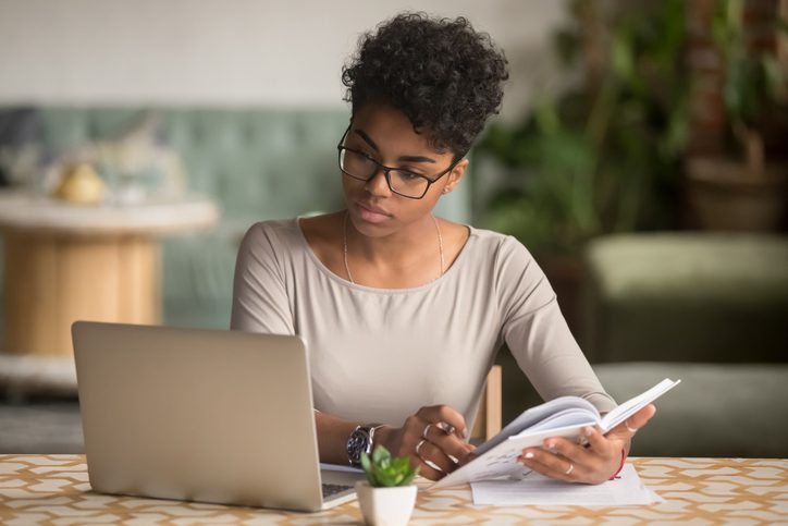 young woman looking at her laptop