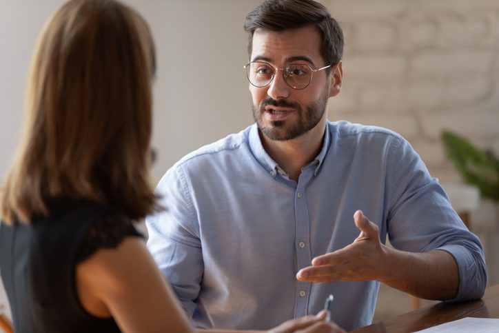 man talking to businesswoman