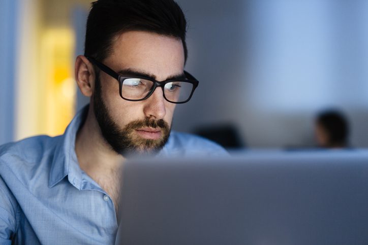 man working late on laptop