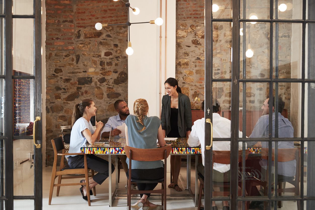 businesswoman addressing her employees