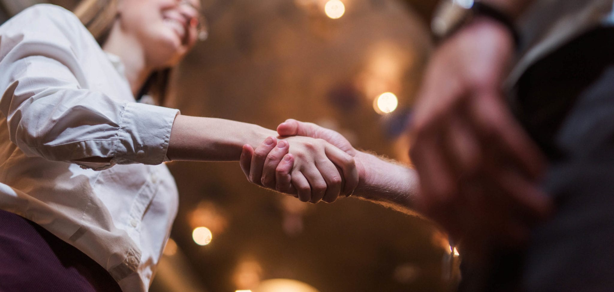 Young woman found a job and shakes hand with colleague