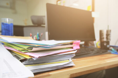 Stacks of paper files information on work desk office. Business concept