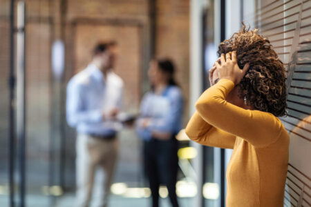 Stressed employee intern suffering from gender discrimination or unfair criticism.