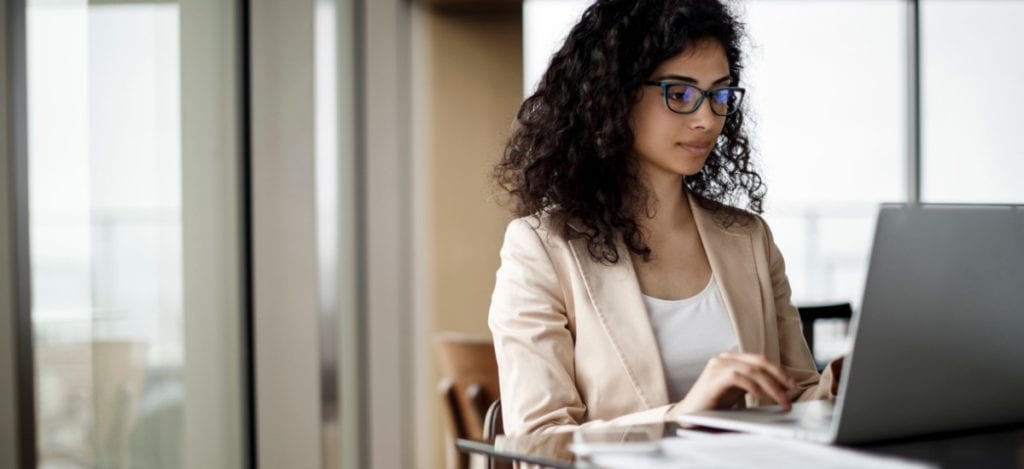 Business women in coffee shop working on a laptop