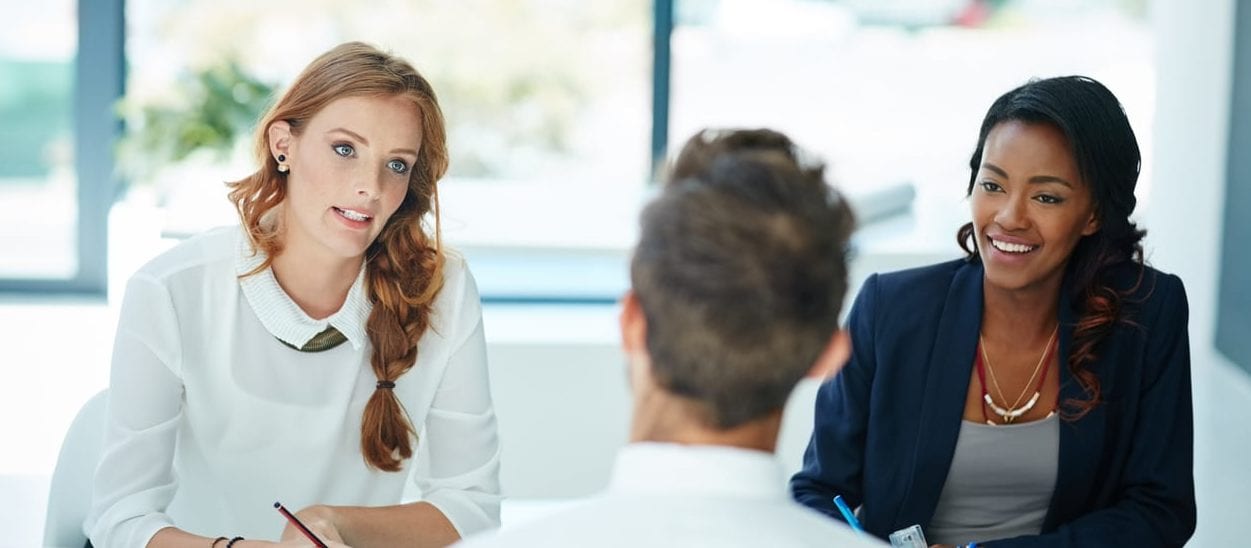 Cropped shot of a man being interviewed by two businesswomen in an office