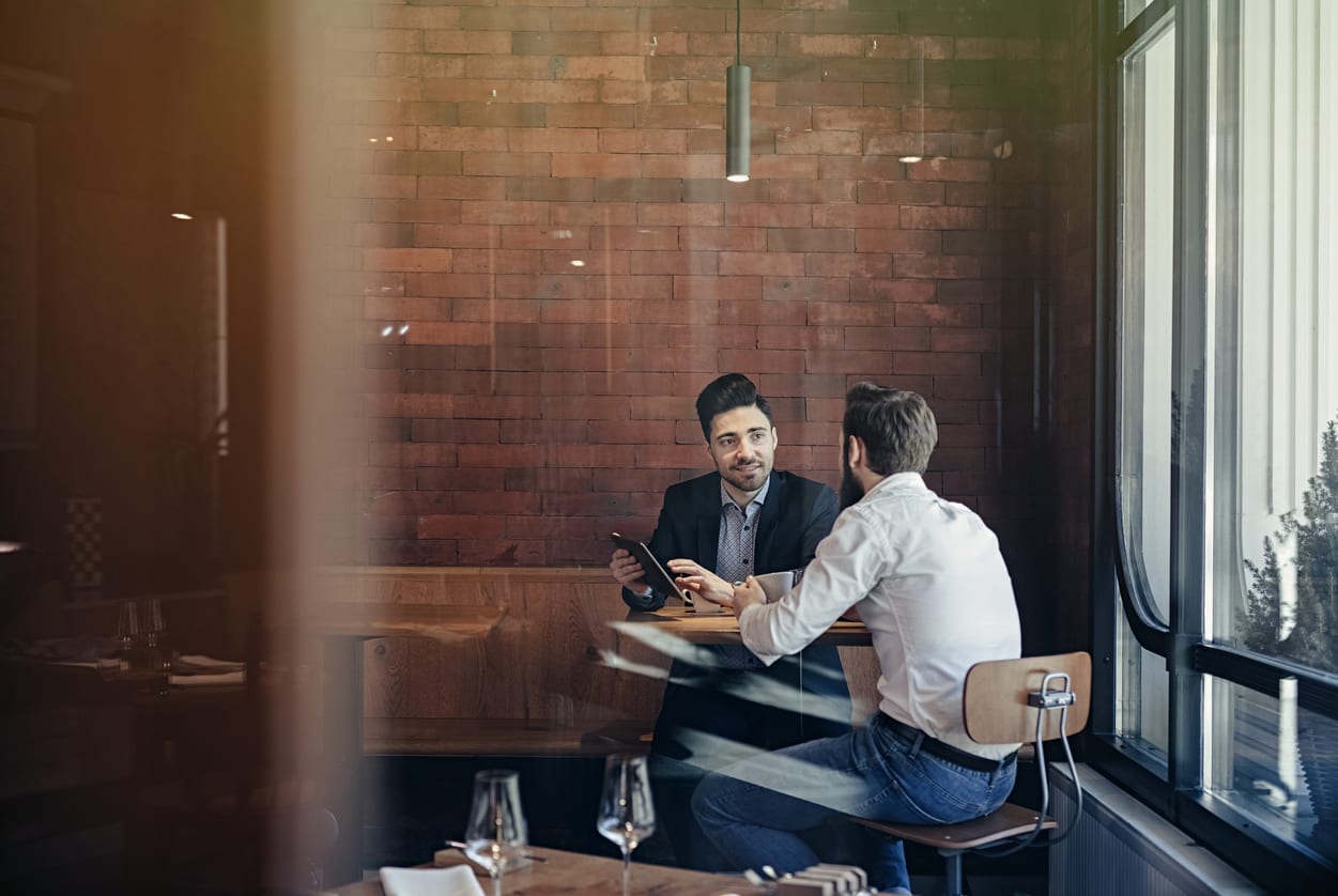 Two Businessmen talking in a cafe