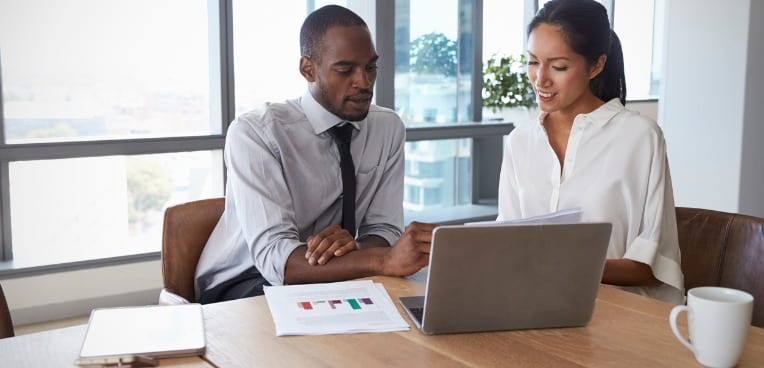 image of colleagues talking in boardroom