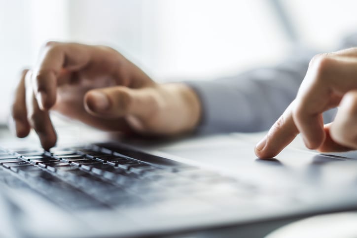 hands typing on keyboard