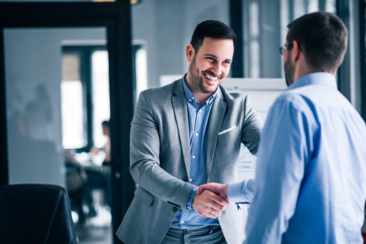 siling businessmen shaking hands