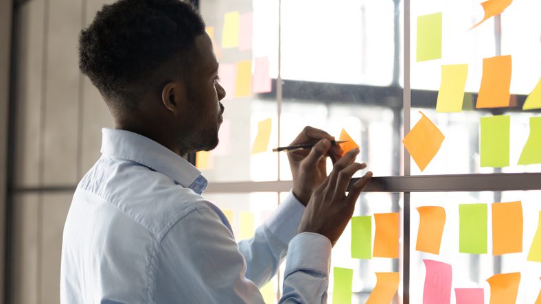 Focused biracial employee engaged in creative thinking at workplace