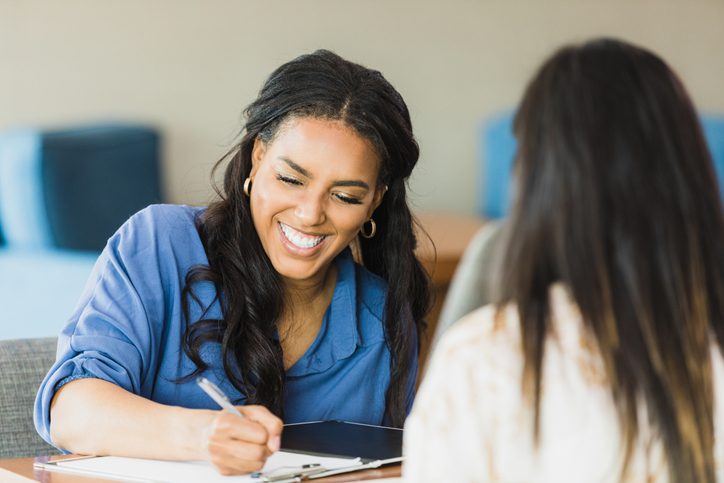 Female business owner smiles while conducting interview