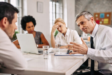 Angry businessman discussing with colleague during a meeting in the office.