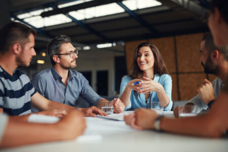 Shot of a group of coworkers having a meeting in an open plan office