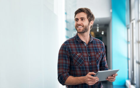 Shot of a young designer using his digital tablet in a office