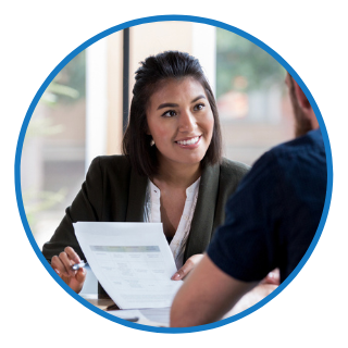 A women in a suit smiling at employees