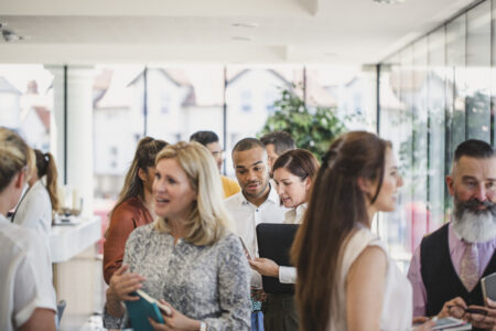 Business professionals attending business conference, networking, busy, discussion, collaboration