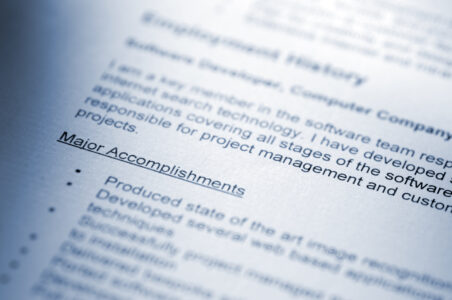 blue tinted selective focus image of resume