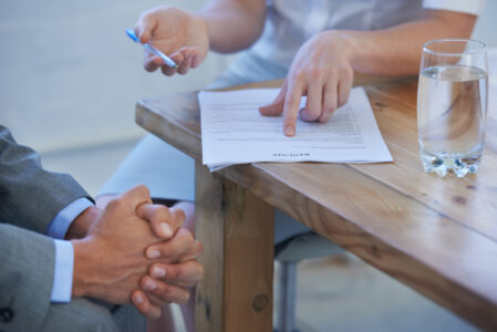 Cropped image of two businesspeople discussing a resume