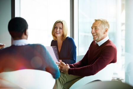 Shot of a group of smiling coworkers having a meeting in an office