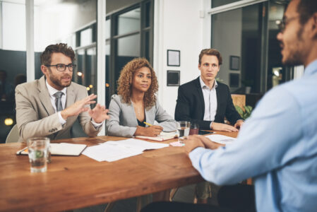 Shot of a group of businesspeople interviewing a candidate in an office