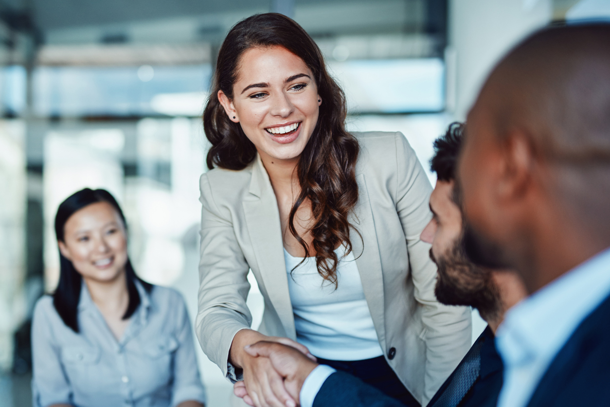 Female prospect shaking hands with possible bosses