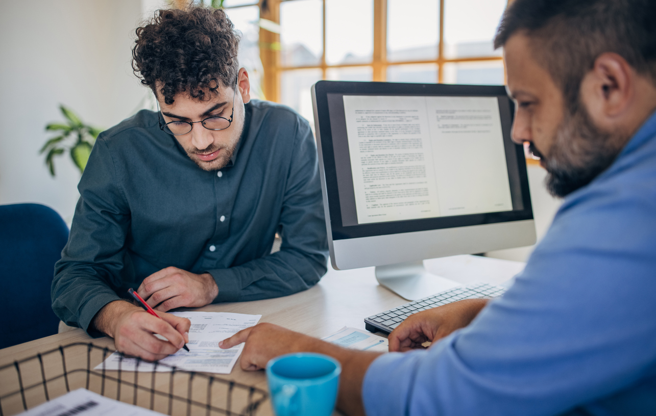 Boss and employee reading through a job prospects CV