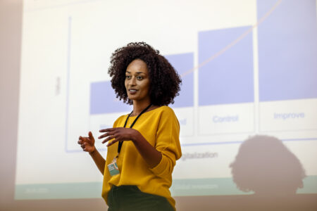 Women in yellow knitted jumper doing a presentation