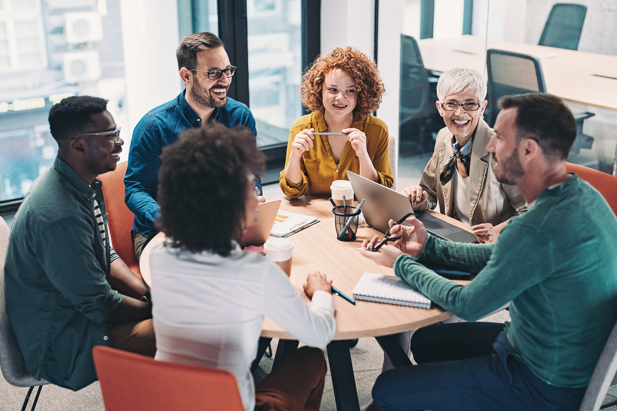 Mixed group of ages speaking at a small table